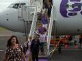 Customers disembark Bonza airlines' inaugural flight from the Sunshine Coast into Newcastle Airport in March, 2023. Picture by Jonathan Carroll.