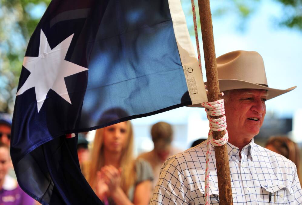 PATRIOT: Federal Member for Kennedy Bob Katter proudly waves an Australian flag. Photo: Mr Katter's electorate office. 