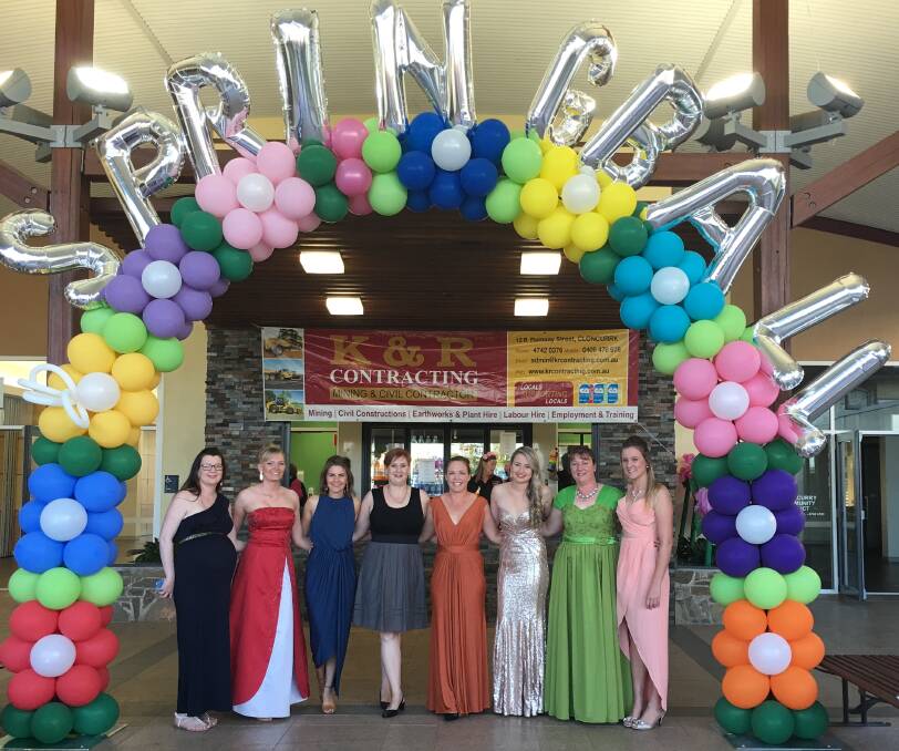 COLOURFUL: The Cloncurry Spring Ball committee members stand under the balloon archway created by Aunty Kags Creations. Photo: Contributed.