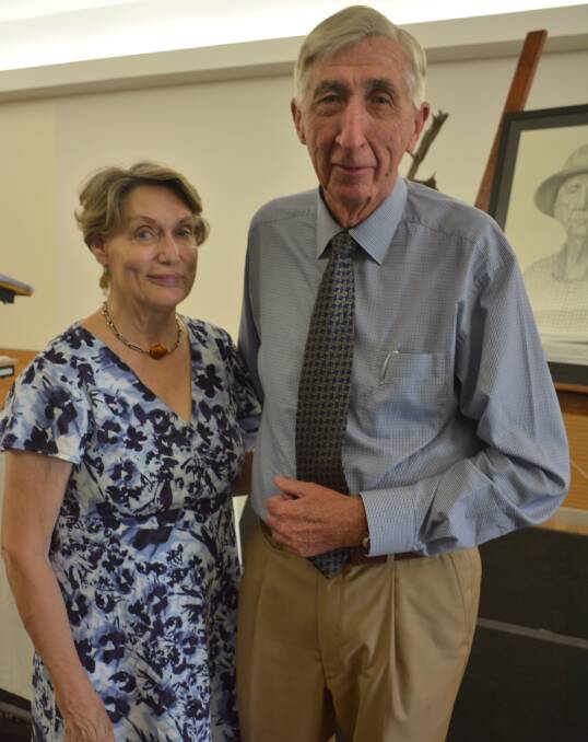 Milestone: Susan and Bob McDonald in front of Bob's portrait. It is printed on the Weekender cover, courtesy of Alice Finlay. 