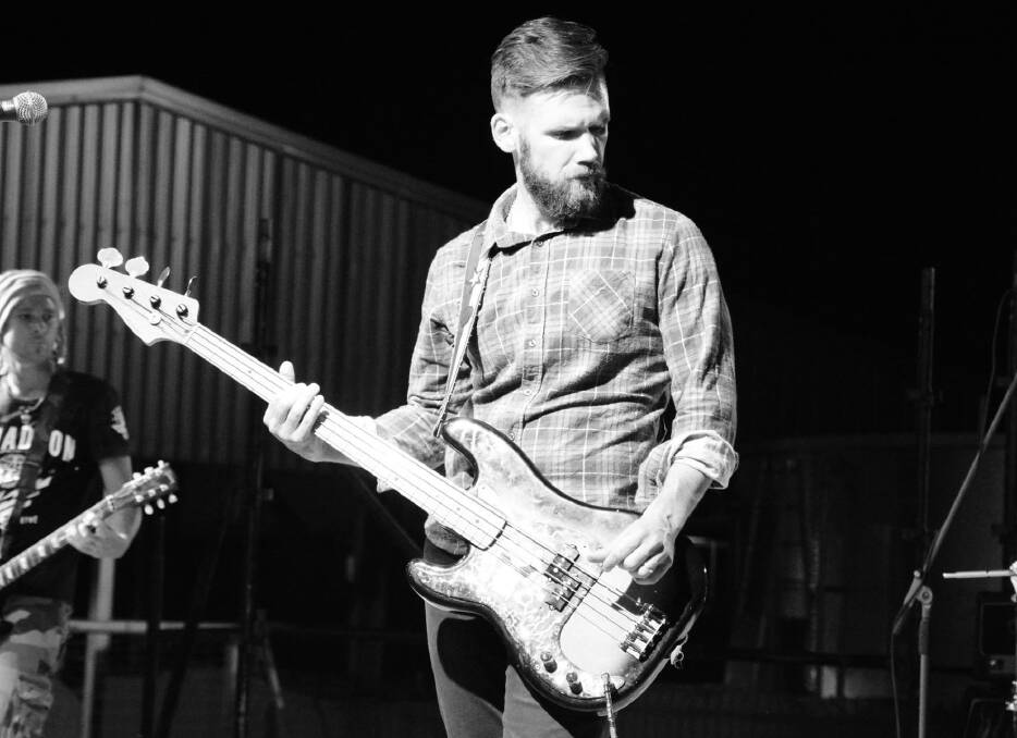 DEEP IN THOUGHT: A monochrome photo of BullDust bass player Peter Tuppurainen looking thoughtful at a recent gig in Mount Isa. Photo: Chris Burns. 