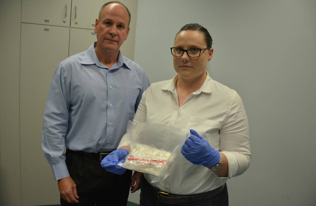 Detective Sergeant Warren Ford and plain clothes officer Senior Constable Kate Plant with the Ice-Amphetamine alleged to have been found by a 39-year-old man at the Mount Isa Airport. Photo: Chris Burns. 