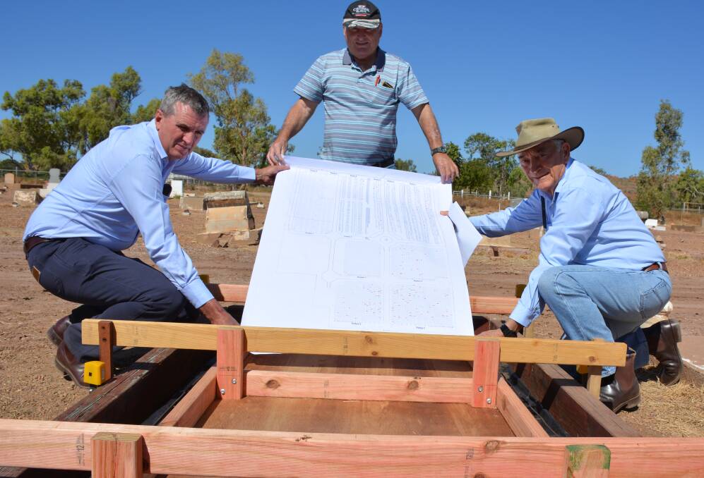 VETERAN GRAVES: Mount Isa RSL sub-branch members Stephen Carrington, Steve Wollaston and Les Bunn examine a chart of more than 200 veterans buried in the cemetery. 
