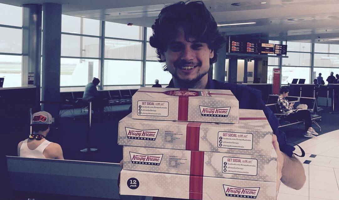 SUGAR TOOTH: North West Star journalist Chris Burns stocking up on his Krispy Kreme while at the Brisbane Airport. He can save himself a trip by ordering at the Mount Isa airport this time. 