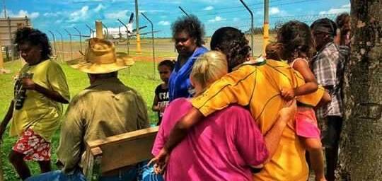 Gathering around: Locals wait at the Mornington Island airport, the main way off and on the indigenous gulf community. Photo: Steve Hodder Watt. 