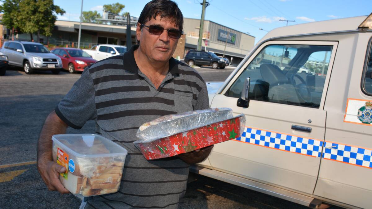 Mount Isa resident Mark Reading delivers food to the police station to make sure emergency service workers don't forget to each while searching at Lake Moondarra. Photo: Chris Burns. 