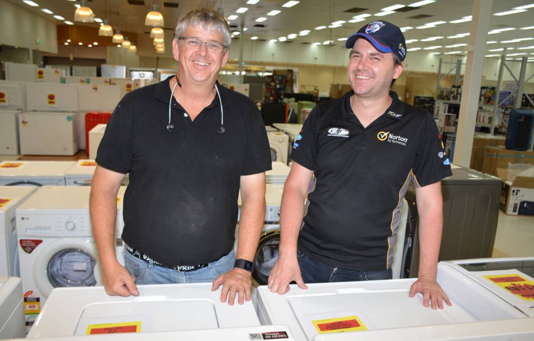 Mount Isa franchisees Brian Bower and Brad Sheppard check out the range of washing machines. Photo: Chris Burns. 