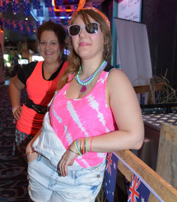 BACK TO THE ’80S: Jaydee Jones and Amber Syrls are dressed to party at the Buffs on the eve before Australia Day. Photo: Chris Burns