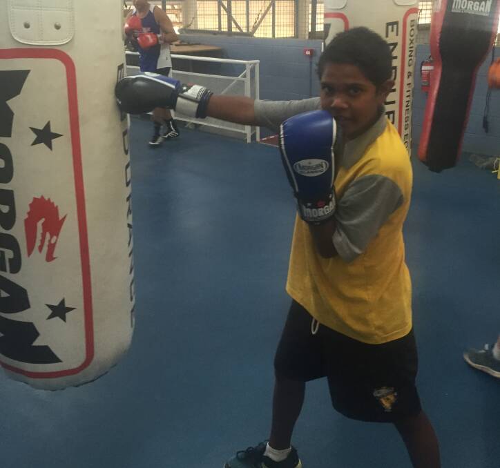 PREPARING: Nathaniel Armstrong, 11, warms up for his fight night against Mannix Hunt from Barcaldine. They have faced each other before. Photo: Sergeant Heidi Rix. 