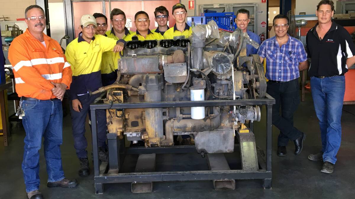 Tafe staff and students and Adrian Pope with the engine. 