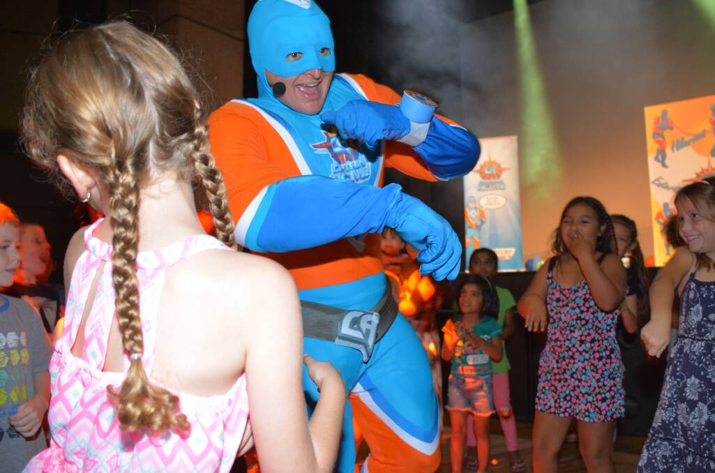 LET'S DANCE: Captain Active is in the middle of a mosh pit of dancing children in the Mount Isa Civic Centre. They somehow are able to keep up the energy despite the fast pace. Photo: Chris Burns. 