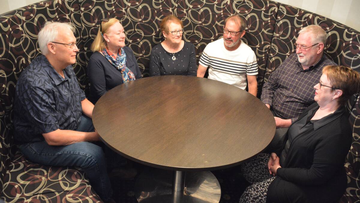 REMEMBERING OLD TIMES: Mark Seay, Gail Seay (nee James), Leonie Joseph (nee Russell), John Joseph, David Stubbs, and Beverley Stubbs (nee Price-Jones) sit in a booth at the Red Earth, recalling the drinks they bought as young teachers. 