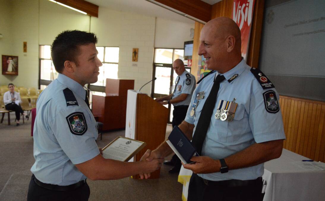 RECOGNISED: Constable Wayne Querruel shakes hands with acting deputy Commissioner Paul Taylor when presented with his award.