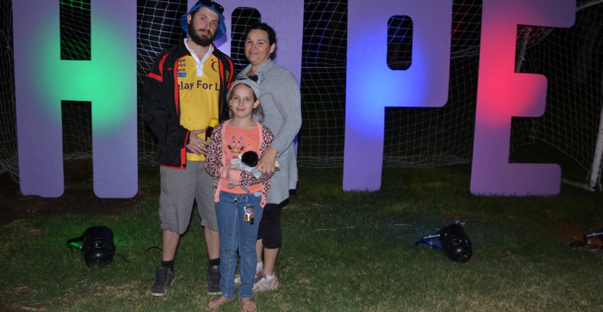 Phillip, Aiyshus-Jade, 8, and Codie Kemp pose for a family photo after the candlelight service held at Tony White Oval on Saturday night. 