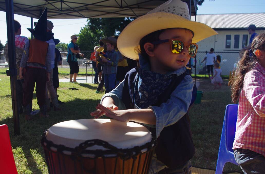COWBOYS WITH DRUMS: Freddie Griffin, 3, gets noisy during the drum beat workshop at the Cloncurry Mega Playgroup. Photo: Centacare. 