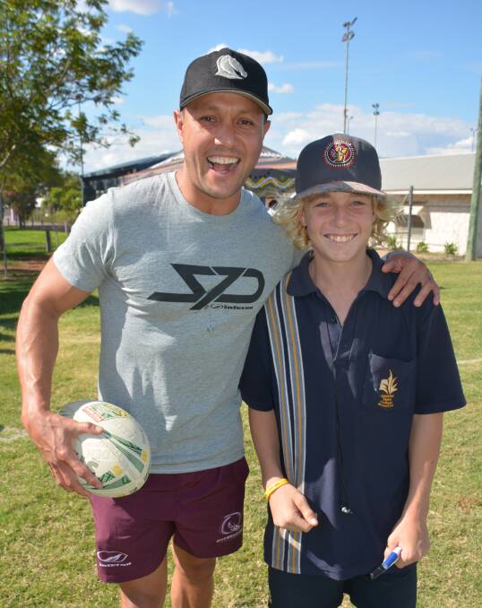 ALL SMILES: Deadly Choices ambassador Scott Prince and Reiley Bishop at a footy workshop in Mount Isa last year. Photo: Chris Burns. 