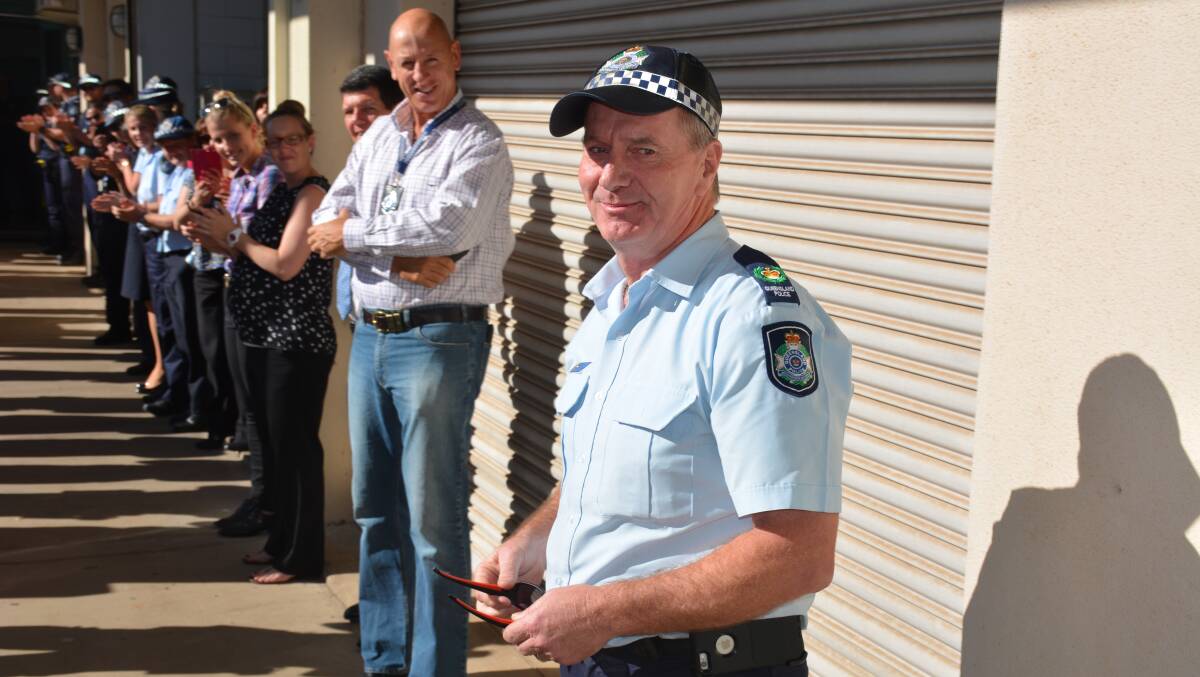 FAREWELL: Senior Sergeant Col Henderson leaves the Mount Isa Police Station during the piping ceremony. Northern Region Assistant Police Commissioner Paul Taylor and Mount Isa Police District officers. Photo: Chris Burns. 