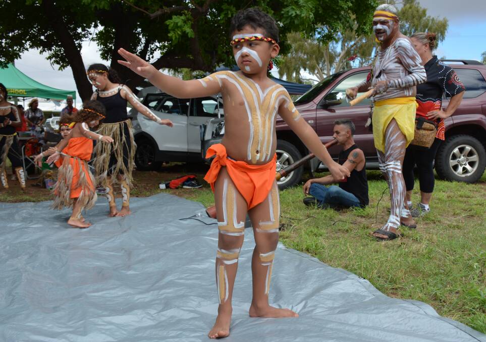 IN ACTION: Mathias Blackley, 6, performs with the Sundowners dance troupe at Yallambee, as songman Ron Guivarra looks on. Photo: Chris Burns. 
