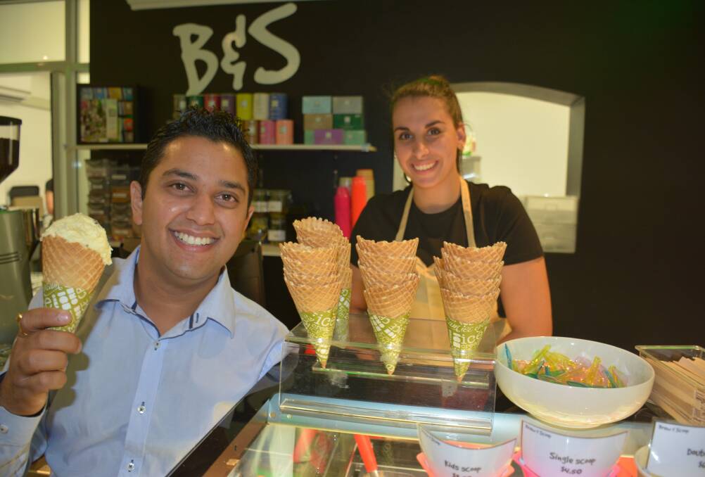 TASTE TEST: Brew & Scoop owner Vipul Gupta tries out an ice-cream served by Sonia Martinez. Photo: Chris Burns. 