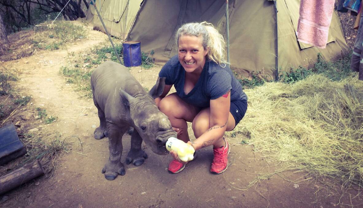 ROUND THE CLOCK CARE: Ruby Bell cares for a traumatised rhinoceros, which is four-days-old in this picture. Photo: Supplied. 