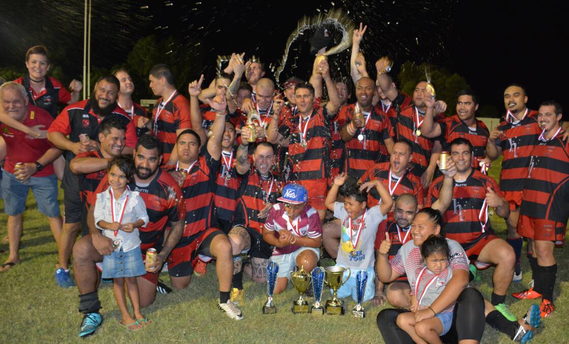 CHEERS: The Euros team celebrate their premiership trophy following the grand final against Warrigals on Saturday night. A lot of beer was sprayed that night. Photo: Chris Burns. 