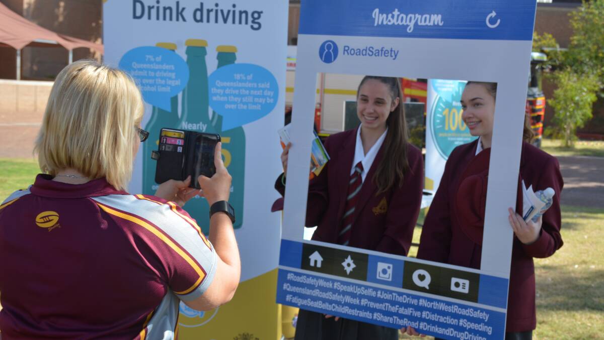 SNAPSHOT: Good Shepherd Catholic College Year 11 pastoral leader Mel Allen takes a photograph of students at the Road Safety Week stand at the Mount Isa Civic Centre lawn. Photo: Chris Burns. 