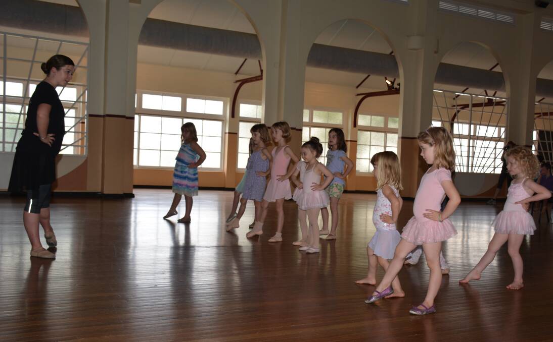 EAGER TO LEARN: Queensland Ballet dancer Martha Godber teaches Cloncurry's aspiring ballerinas basic dance technique, which they absorb remarkably quickly. Photo: Chris Burns. 
