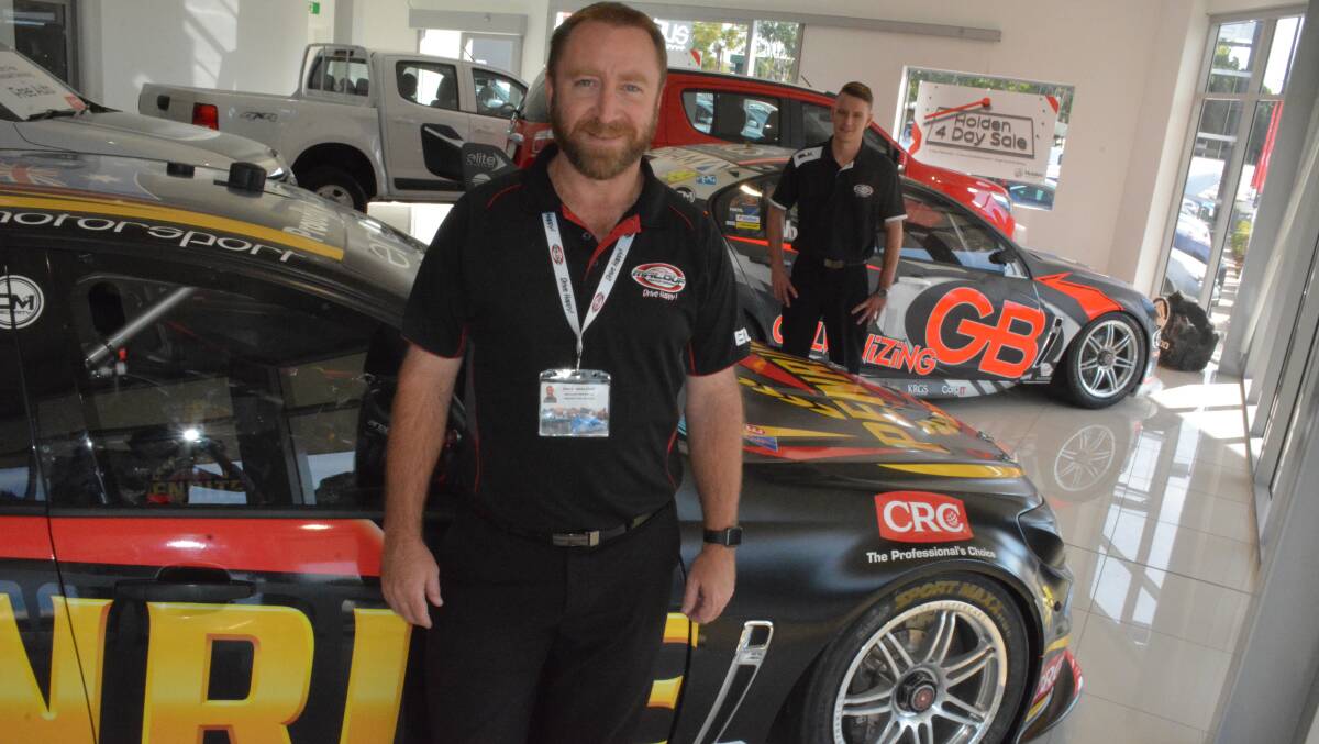 PROUD SPONSORS: Dealer principal Paul Malouf and sales consultant Michael Counsell with the genuine race cars displayed in the dealership. Photo: Chris Burns. 