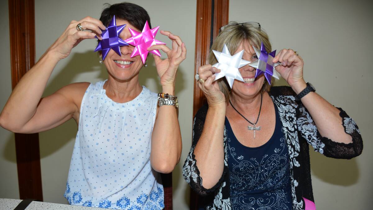 STARRY EYED: Zonta Club members Arlene Turner and Sue Reinke make silk stars at the Ibis Hotel on Thursday evening, where they are offered snacks and wine. Photo: Chris Burns. 