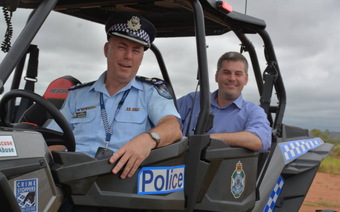 LET'S ROLL: Mount Isa Police District Acting Superintendent Chris Hodgman and Police Minister Mark Ryan try out the new buggy. Photo: Chris Burns. 