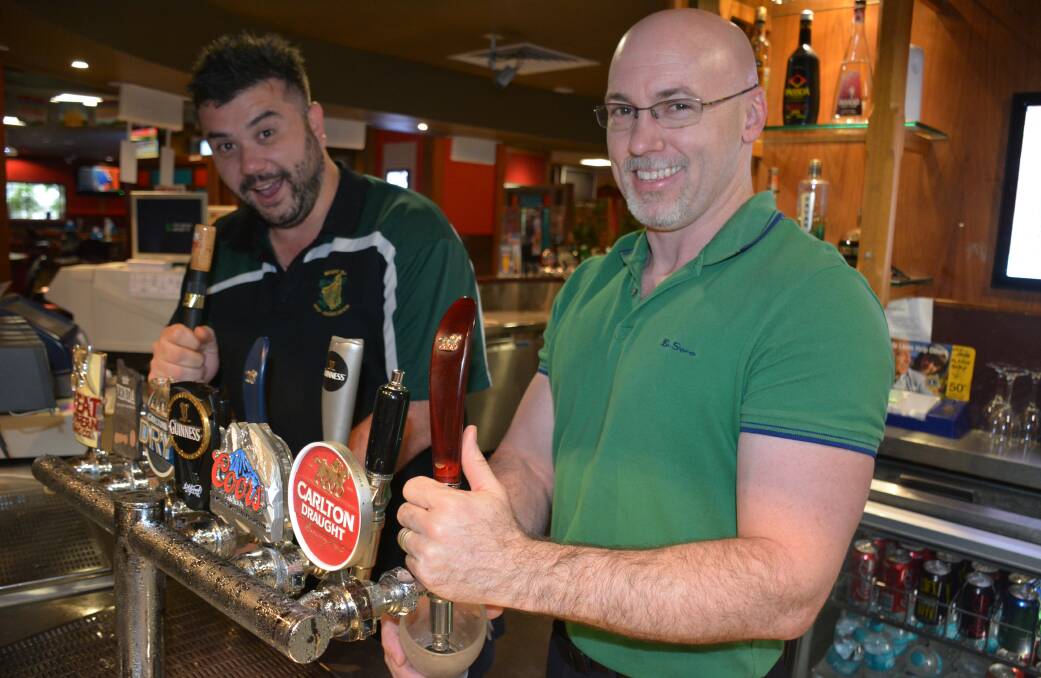 HARD EARNED: Irish Club employee Akos Schneider is thrilled his rates won't decrease. He's pictured with manager Bernard Gillic. Photo: Chris Burns. 