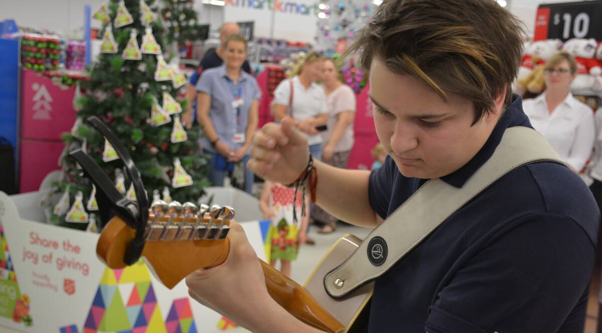 Inspiring the givers: Musician James Trew performs Winter Wonderland at the Kmart Christmas Tree appeal launch on Wednesday morning. Picture: Chris Burns