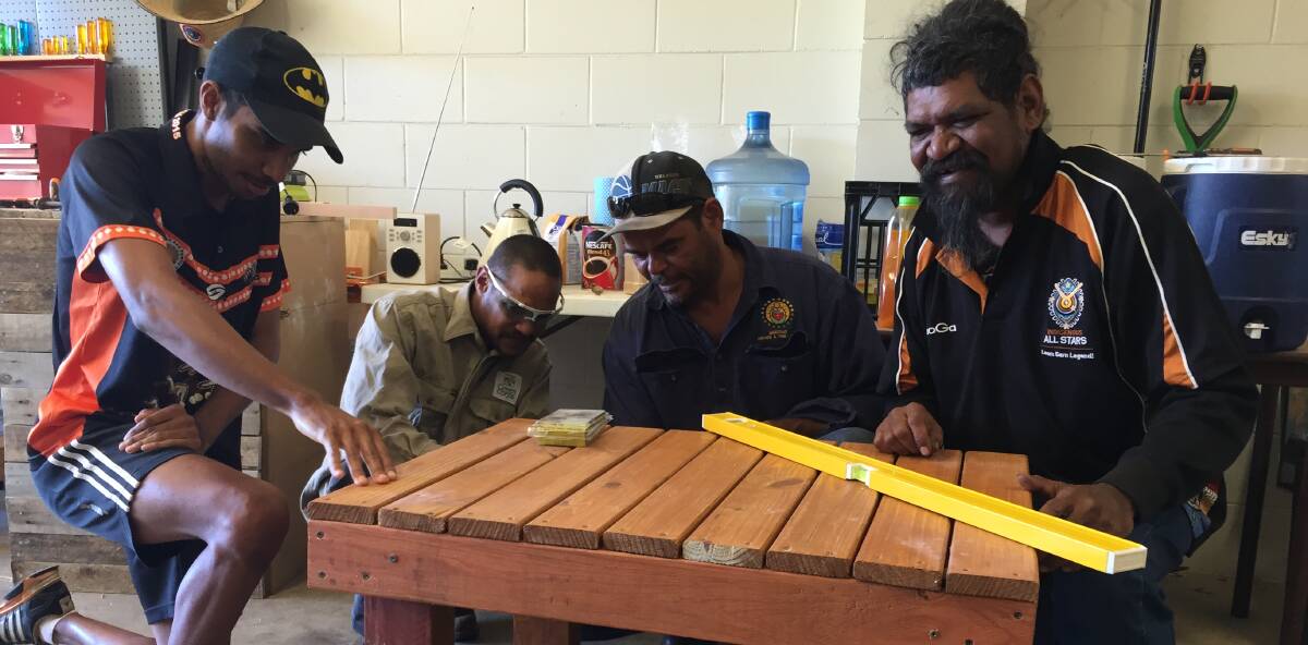 Looking busy: Men's Shed members Kale Johnson, Juhani Mursunen, Gary  Hartman and Troy Wilde make a table from a crate. Photo: Chris Burns.