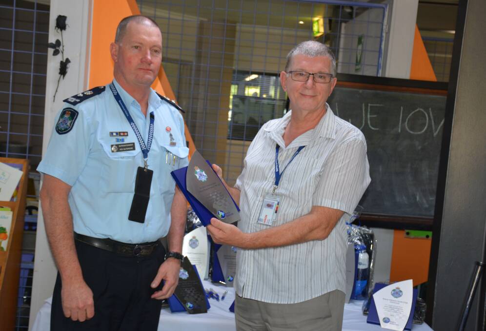 Mount Isa Police District Superintendent Kev Guteridge recognises the work of ATODS. A trophy is collected by ATODS representative Jason Pelcher. 