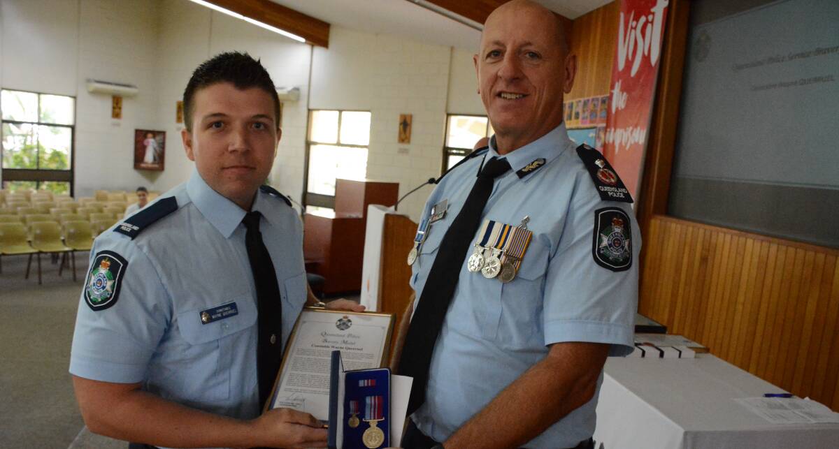 ACKNOWLEDGED: Constable Wayne Querruel receives a QPS Bravery Medal for his work in attending a caravan explosion. Photo: Chris Burns.