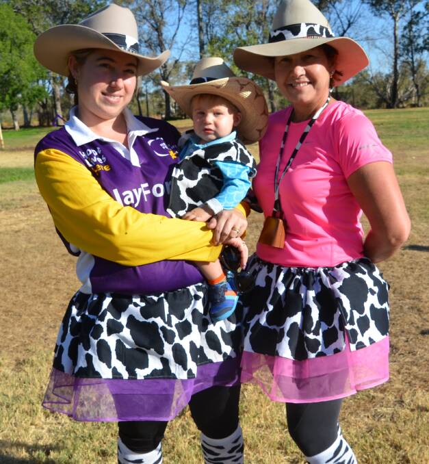 Robyn Braes, Charlie Braes, 1, and Katreana Cunningham, from Team Allsorts, walk around Tony White Oval on Saturday afternoon. 