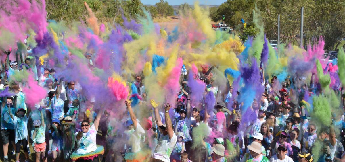 COLOUR THROW: Colour for Cancer attendees use the last of their paint in one last burst at Lake Moondarra on Sunday morning. Photo: Chris Burns. 