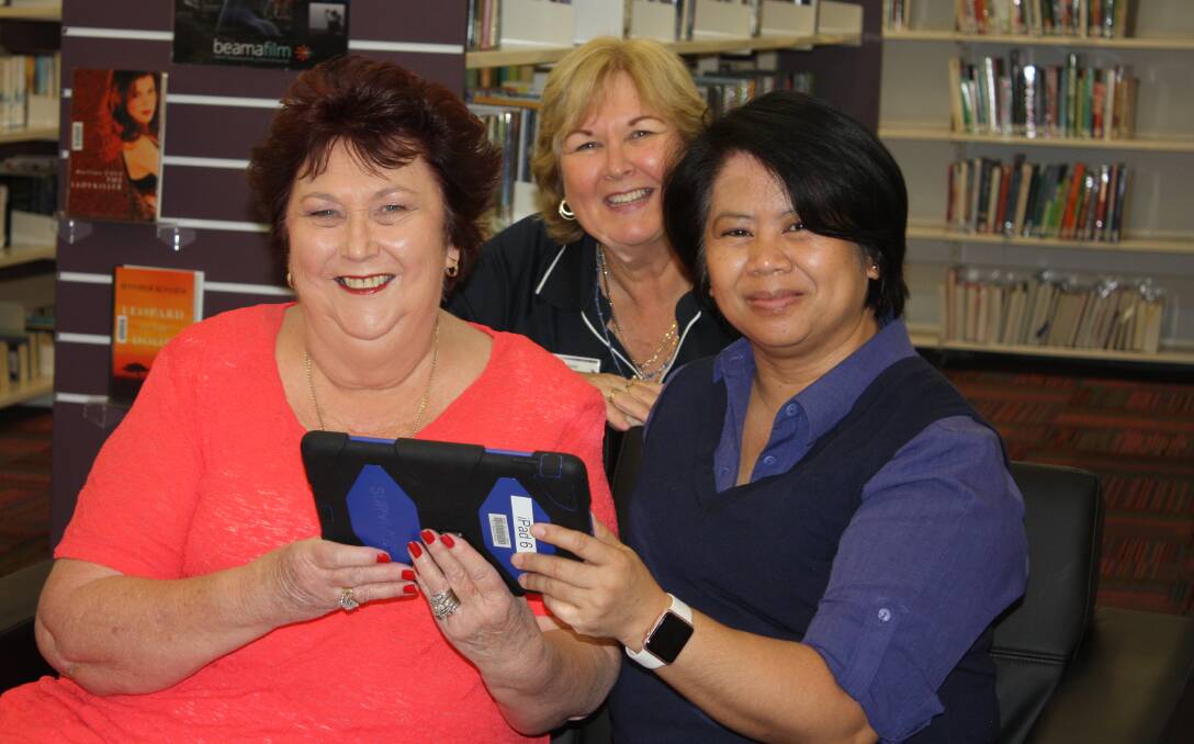 ADAPTING: Cr Jean Ferris, coordinator of library services Astrid Hancock and tech savvy trainer Merlita Perry practise using an Ipad. Photo: Supplied.