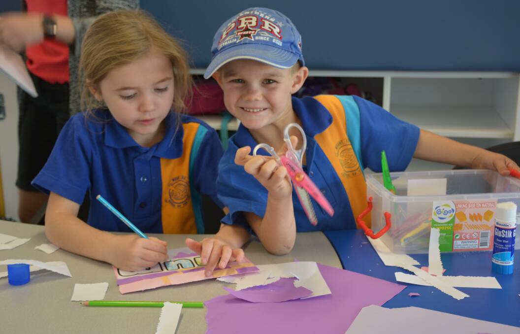 PREPARING GIFTS FOR MUM: Mount Isa School of the Air Year 2 students Rieley Williams, 7, and Maverick Hills, 6, prepare cards. Photo: Chris Burns. 