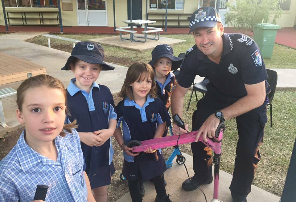 A recent photograph on the Cloncurry Cops Facebook page. Local police visit a school to take down serial numbers of students' valuables. Photo: QPS. 