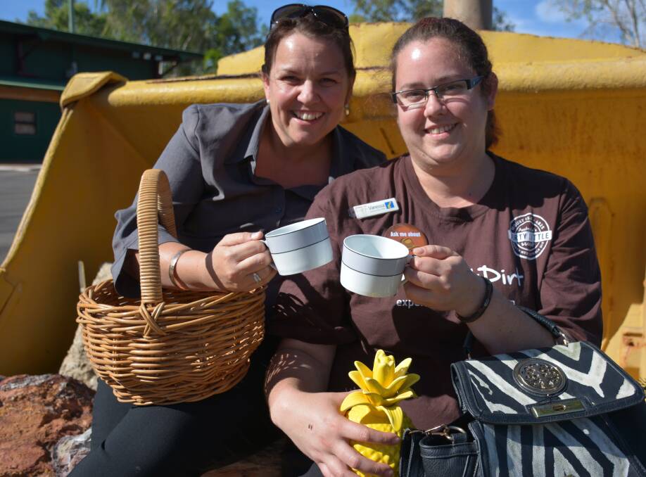 CHEERS: Kylie Rixon and Vanessa Crosbie gather some items around Outback at Isa that they may be able to sell. Photo: Chris Burns. 