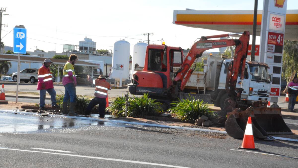 Council workers repair the burst water main on the Barkly Highway running through Mount Isa. Photo: Chris Burns. 