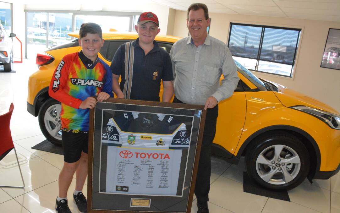 SHOWING SUPPORT: Australian riders Bill and Philip Woodward, with Bell & Moir Toyota principal Lee Pulman. Photo: Chris Burns. 