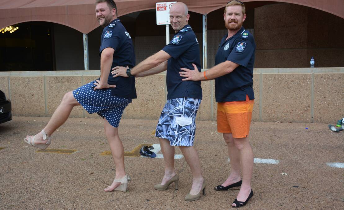 Posing: Senior Constable Jake Lacy, Senior Constable Murray Sanewski and Acting Senior Sergeant Brendan Poustie steady themselves in high heels, used to complete their relay. 
