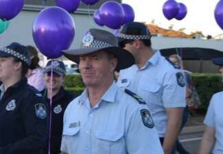 INVOLVED: Senior Sergeant Henderson marches as part of an anti-domestic violence march held in the Mount Isa central business district.  
