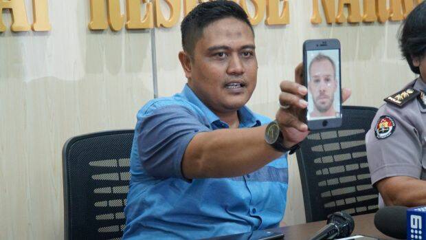 The deputy director of narcotics for Bali police, Sudjarwoko, holds a photo of Joshua James Baker. Photo: Amilia Rosa