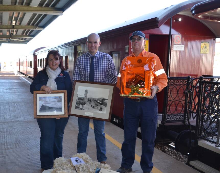 HERE's TO 'CURRY: Cr Vicky Campbell, Mayor Greg Campbell and QR's Paul Naylor with the C150 steam train and anniversary gifts received from other councils. 
