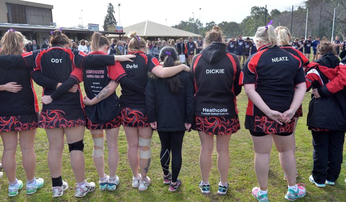 Netballers, footballers and spectators from Heathcote paused for a minute's silence on Saturday out of respect for the family who lost their 15-year-old daughter. Picture: BRENDAN McCARTHY