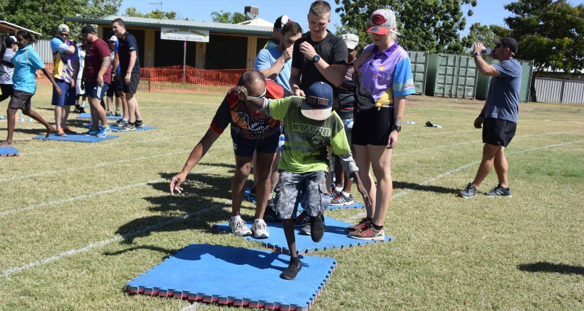 FOLLOW THE LEADER: Mount Isa Flexible Learning Centre kids lead the way for their police mentors during a team building exercise at Sunset Oval. Photo: Danaella Wivell