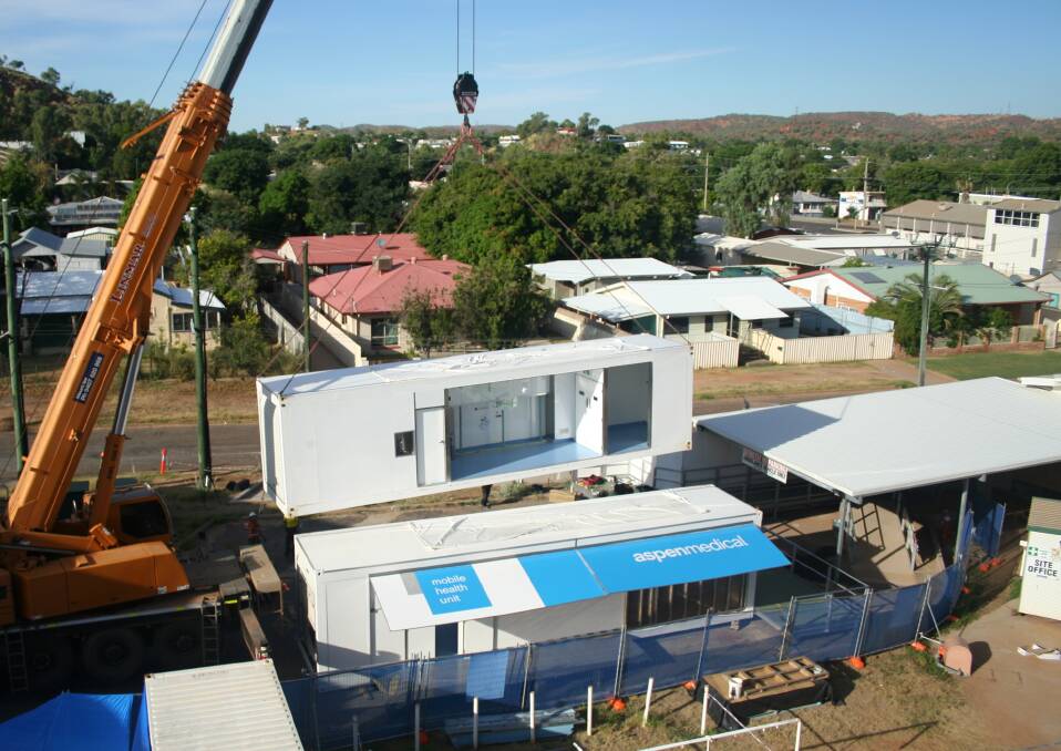 Aerial view of installment of the second mobile theatre unit being lowered at Mount Isa Hospital carpark. Photo: supplied